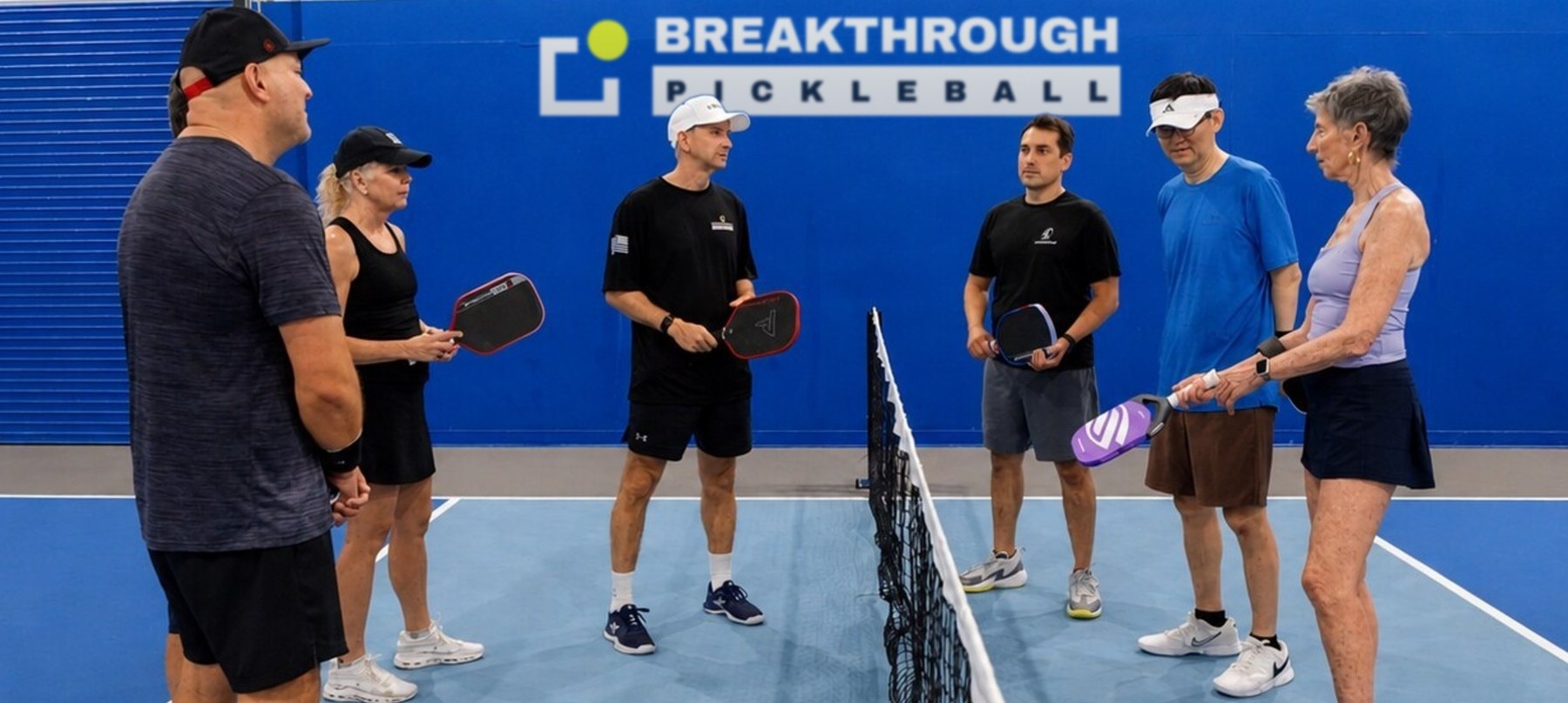 Breakthrough Pickleball campers being coached on an indoor court