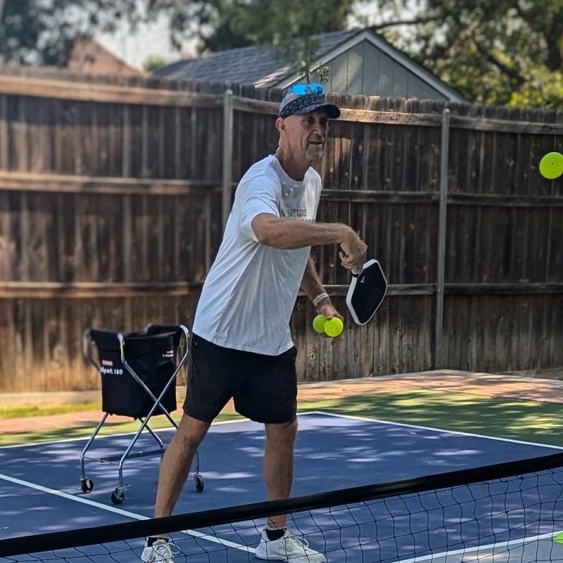 Coach Shawn Smith feeding balls during a drill
